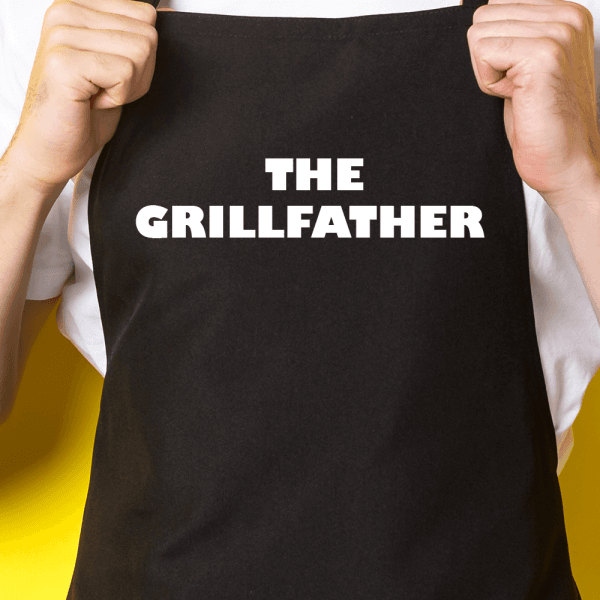 Zwart keukenschort / BBQ-schort met tekst | The Grillfather